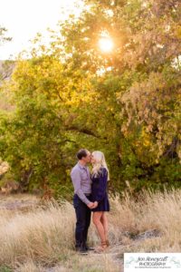 Littleton family photographer Hildebrand Ranch Colorado barn park foothills fall at sunset natural light photography mother father son little boy yellow trees twirling and kisses