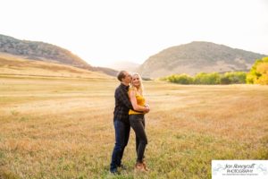 Littleton family photographer Hildebrand Ranch Colorado barn park foothills fall at sunset natural light photography mother father son little boy yellow trees twirling and kisses