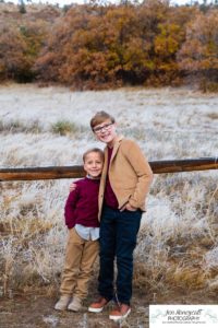 Littleton family photographer in Colorado South Valley Open Space park Ken Caryl red rocks rock formations boys brothers fall photo session cold frost winter mother father sons sunset photography