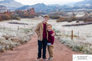 Littleton family photographer in Colorado South Valley Open Space park Ken Caryl red rocks rock formations boys brothers fall photo session cold frost winter mother father sons sunset photography