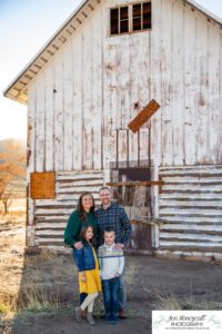 Littleton family photographer Hildebrand Ranch Colorado farm barn boy girl siblings brother sister mother father sunset golden natural light photography foothills view children kids broken arm