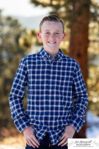 Littleton family photographer in Colorado at Mt. Falcon park snow fall winter kids children big brother little sister mountain view views foothills