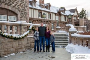 Littleton family photographer in Colorado at the Highlands Ranch Mansion in the snow boys brothers Christmas winter stone building iron gate