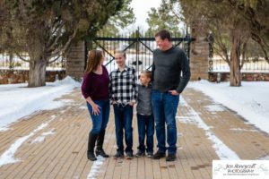 Littleton family photographer in Colorado at the Highlands Ranch Mansion in the snow boys brothers Christmas winter stone building iron gate