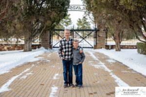 Littleton family photographer in Colorado at the Highlands Ranch Mansion in the snow boys brothers Christmas winter stone building iron gate