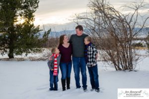 Littleton family photographer in Colorado at the Highlands Ranch Mansion in the snow boys brothers Christmas winter stone building iron gate