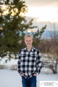 Littleton family photographer in Colorado at the Highlands Ranch Mansion in the snow boys brothers Christmas winter stone building iron gate