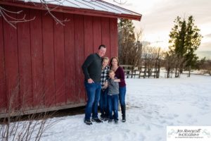 Littleton family photographer in Colorado at the Highlands Ranch Mansion in the snow boys brothers Christmas winter stone building iron gate