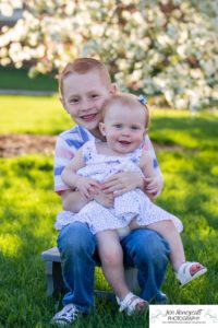 Littleton family photographer pink and white crab apple tree blossoms spring Denver brother sister mother father expecting baby bump little big sunset daughter son mother's day photo session