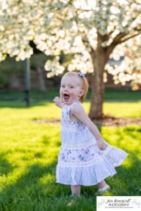 Littleton family photographer pink and white crab apple tree blossoms spring Denver brother sister mother father expecting baby bump little big sunset daughter son mother's day photo session