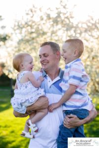 Littleton family photographer pink and white crab apple tree blossoms spring Denver brother sister mother father expecting baby bump little big sunset daughter son mother's day photo session