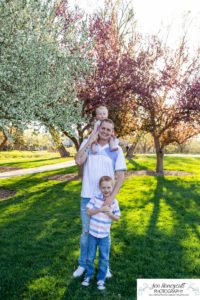 Littleton family photographer pink and white crab apple tree blossoms spring Denver brother sister mother father expecting baby bump little big sunset daughter son mother's day photo session