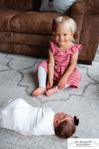 Littleton baby newborn photographer Colorado in home lifestyle sisters mother father daughter natural light connection tiny infant photography