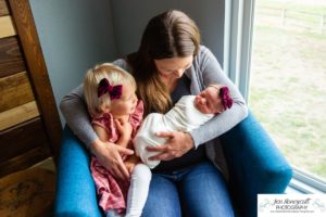 Littleton baby newborn photographer Colorado in home lifestyle sisters mother father daughter natural light connection tiny infant photography