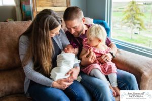 Littleton baby newborn photographer Colorado in home lifestyle sisters mother father daughter natural light connection tiny infant photography