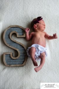 Littleton baby newborn photographer Colorado in home lifestyle sisters mother father daughter natural light connection tiny infant photography