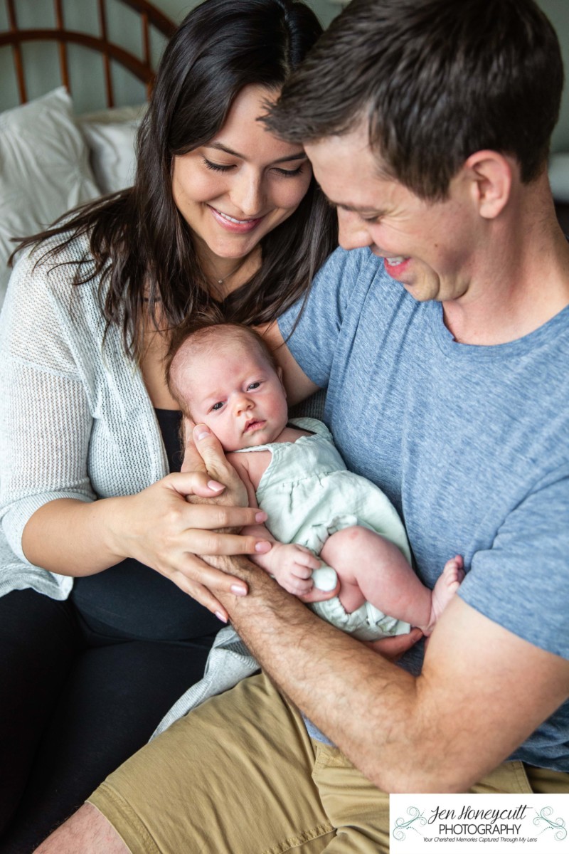 Littleton family and newborn baby photographer in home lifestyle Colorado natural light one month old girl mother father daughter snuggles sleepy crib nursery summer