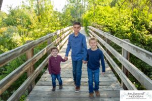 Littleton family photographer at Writer's Vista park in Colorado boy brothers bridge new client fun morning natural light leaves yellow trees