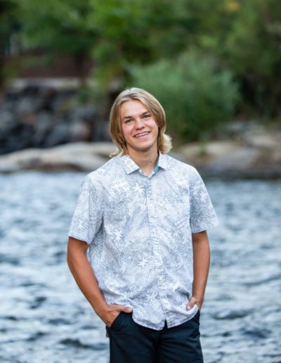 Littleton high school senior photographer teen boy Clear Creek History Park in Golden Colorado ice hockey lacrosse player water river creek sunset foothills view