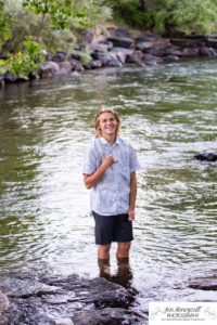 Littleton high school senior photographer teen boy Clear Creek History Park in Golden Colorado ice hockey lacrosse player water river creek sunset foothills view