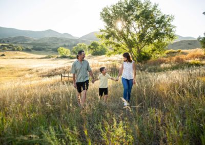 Littleton family photographer mother father son South Valley Open Space park sunset golden hour light photography tall grasses natural pose