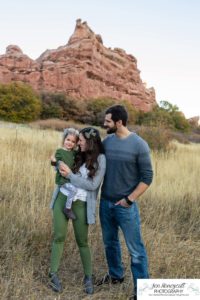 Littleton family photographer South Valley Open Space park Ken Caryl Colorado red rocks daughter little girl mother father guided pose snuggles sunset photography playful real moments