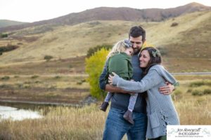 Littleton family photographer South Valley Open Space park Ken Caryl Colorado red rocks daughter little girl mother father guided pose snuggles sunset photography playful real moments