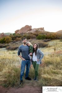 Littleton family photographer South Valley Open Space park Ken Caryl Colorado red rocks daughter little girl mother father guided pose snuggles sunset photography playful real moments
