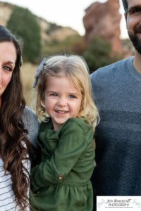 Littleton family photographer South Valley Open Space park Ken Caryl Colorado red rocks daughter little girl mother father guided pose snuggles sunset photography playful real moments