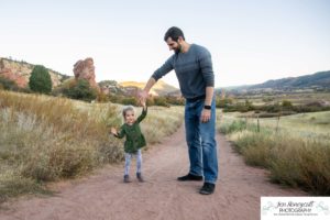 Littleton family photographer South Valley Open Space park Ken Caryl Colorado red rocks daughter little girl mother father guided pose snuggles sunset photography playful real moments