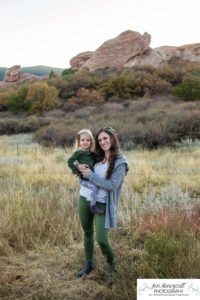 Littleton family photographer South Valley Open Space park Ken Caryl Colorado red rocks daughter little girl mother father guided pose snuggles sunset photography playful real moments