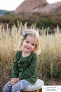 Littleton family photographer South Valley Open Space park Ken Caryl Colorado red rocks daughter little girl mother father guided pose snuggles sunset photography playful real moments