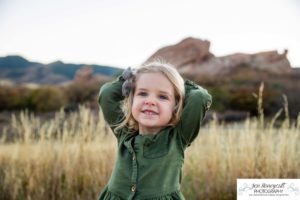 Littleton family photographer South Valley Open Space park Ken Caryl Colorado red rocks daughter little girl mother father guided pose snuggles sunset photography playful real moments