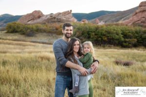 Littleton family photographer South Valley Open Space park Ken Caryl Colorado red rocks daughter little girl mother father guided pose snuggles sunset photography playful real moments