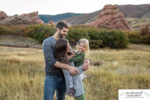 Littleton family photographer South Valley Open Space park Ken Caryl Colorado red rocks daughter little girl mother father guided pose snuggles sunset photography playful real moments