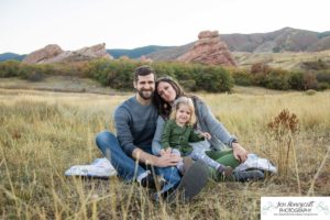 Littleton family photographer South Valley Open Space park Ken Caryl Colorado red rocks daughter little girl mother father guided pose snuggles sunset photography playful real moments