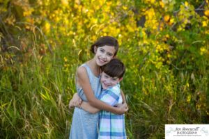 Littleton family photographer Standley Lake Colorado yellow trees leaves fall brother sister beach sand love sunset photography Halloween