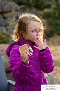 Littleton family photographer mountain camping views Evergreen firepit smores kids roasting marshmallows branding photo session outdoors tent ramble photography