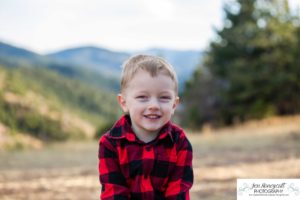 Littleton family photographer Colorado Mt. Falcon park cold wind little boy mountain view fun moments parenthood sunset photography sweet child