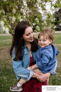 Littleton family photographer Denver City park toddler boy boathouse mother father son spring Colorado photography trees bloom