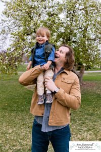 Littleton family photographer Denver City park toddler boy boathouse mother father son spring Colorado photography trees bloom