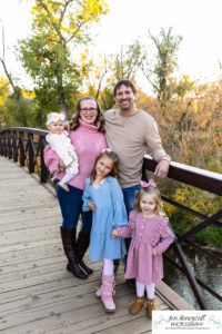 Littleton family photographer Stone House Lakewood greenbelt sunset photography fall leaves trees little girls sisters siblings bridge log cuddles one year old