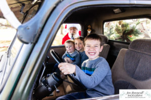 Littleton family photographer mini photo session Christmas truck vintage winter 2022 photography families Santa elf elves kids siblings Colorado