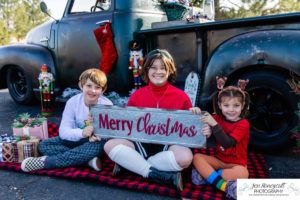 Littleton family photographer mini photo session Christmas truck vintage winter 2022 photography families Santa elf elves kids siblings Colorado