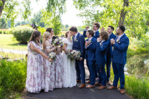 Littleton wedding photographer golf course Colorado photography lake water reflection bride groom married marriage reception ceremony bridal party groomsmen bridesmaids