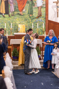 Littleton wedding photographer Colorado Catholic ceremony first kiss bride groom photography married marriage priest