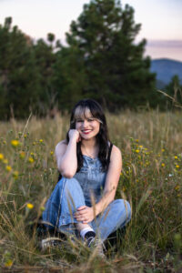 Littleton high school senior photographer teen girl Arvada West class of 2024 Mt. Falcon park Colorado wildflowers mountain view foothills photography sunset