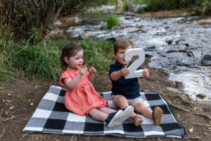 Littleton family photographer Lair O' the Bear park summer twins Colorado photography river water bridge two years old