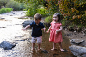 Littleton family photographer Lair O' the Bear park summer twins Colorado photography river water bridge two years old