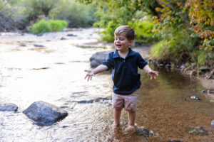 Littleton family photographer Lair O' the Bear park summer twins Colorado photography river water bridge two years old